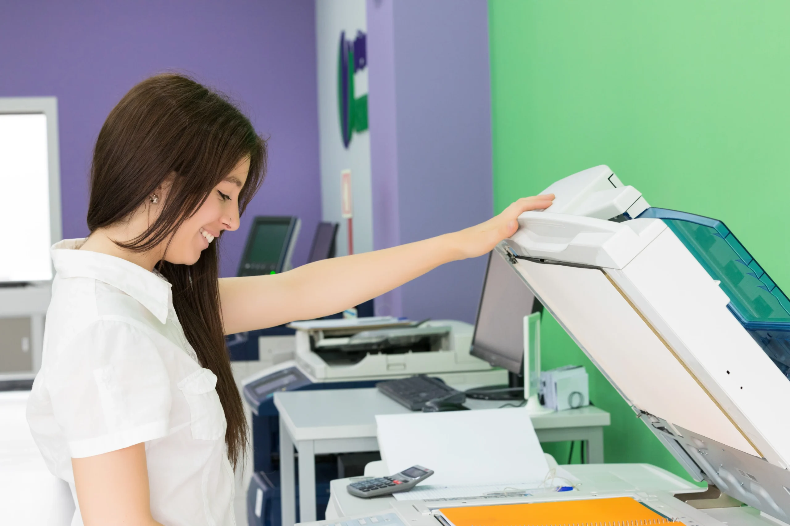 A Young Student At A Copy Center Taking Some Copies For Her Final Exams