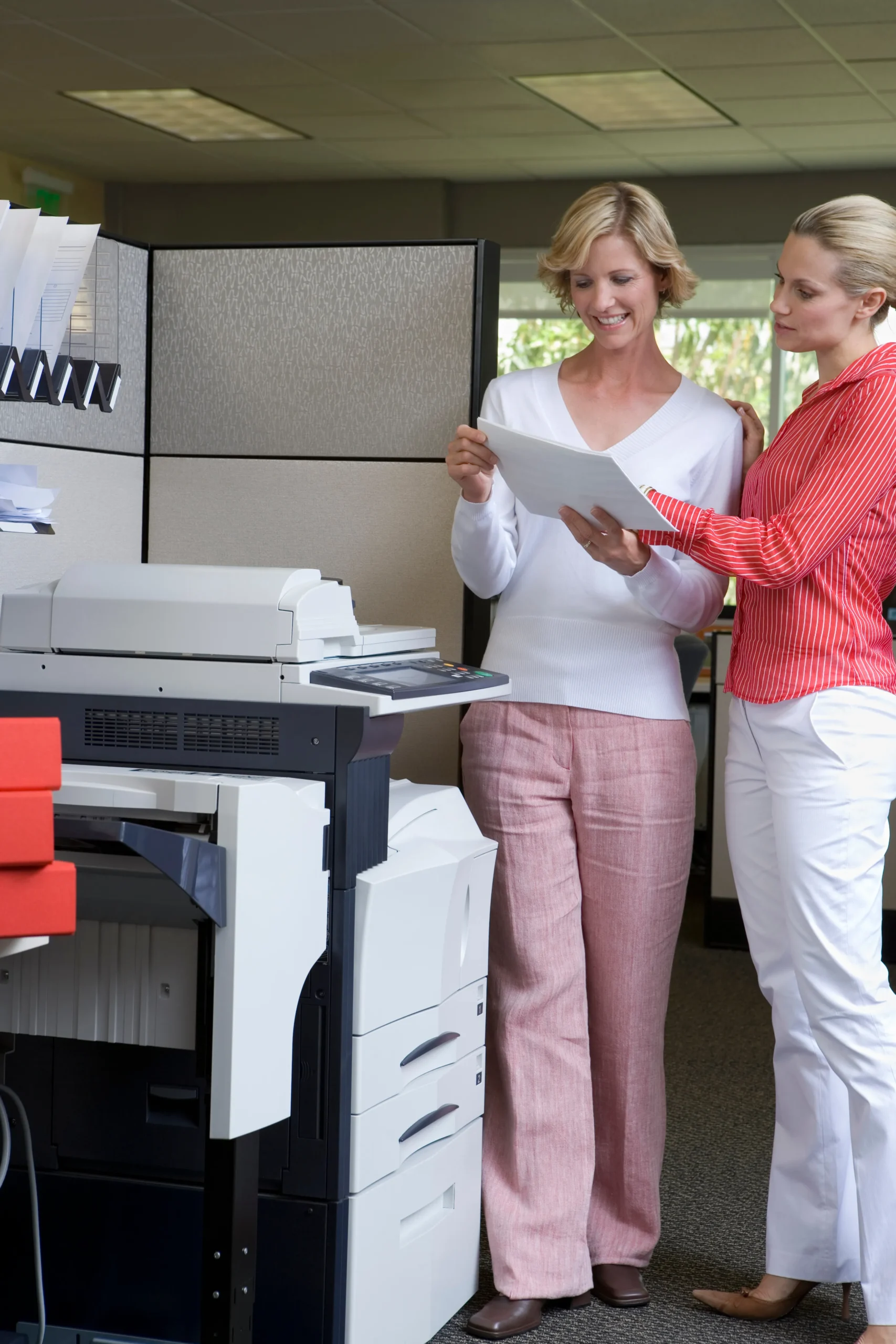 Two Businesswomen Looking At Paperwork